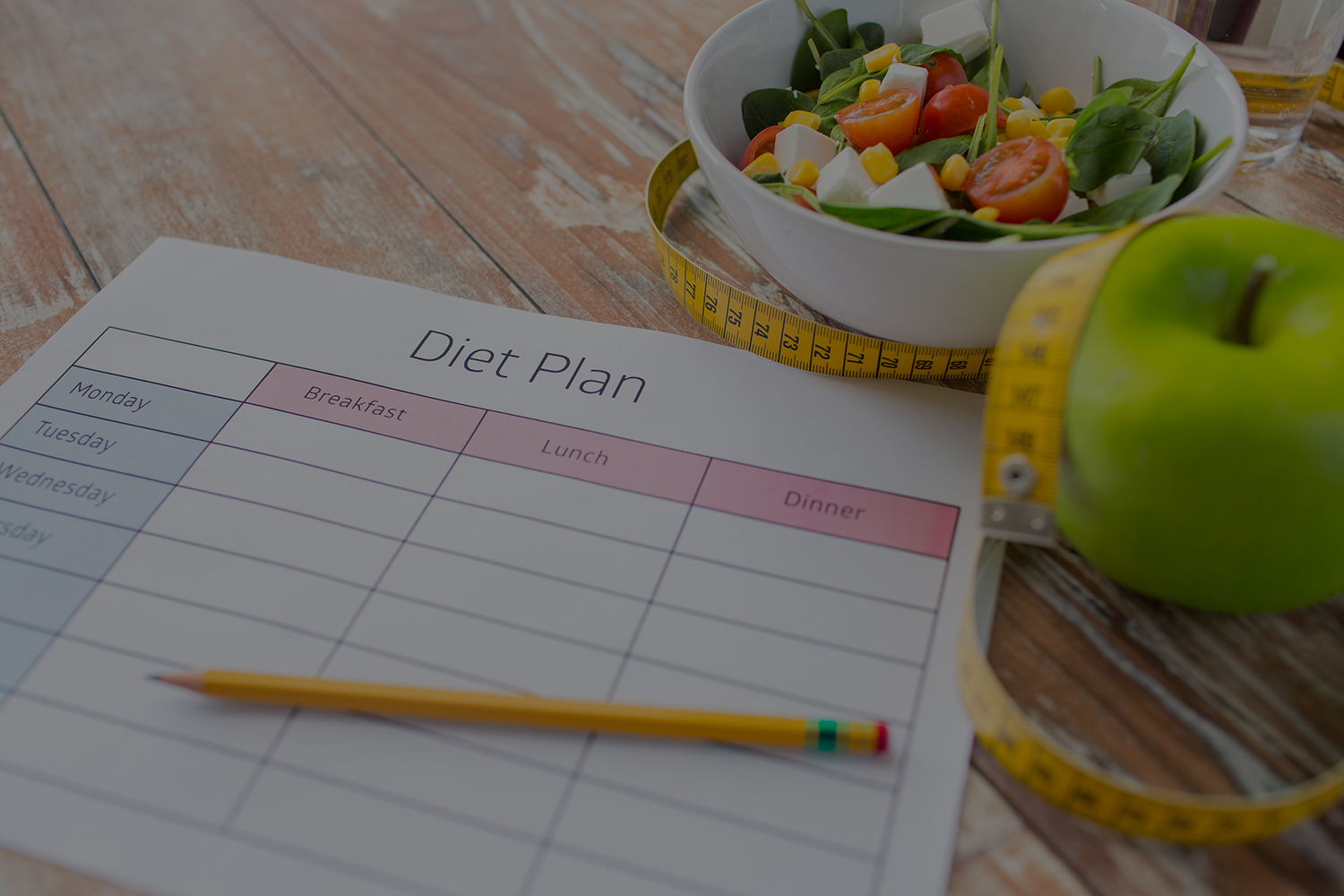 healthy eating, dieting, slimming and weigh loss concept - close up of diet plan paper green apple, measuring tape and salad
